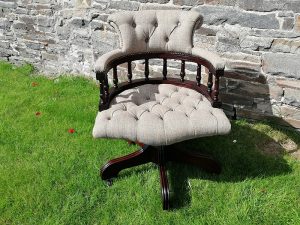 Deep buttoned captain's chair with grey fabric