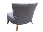 American deep-buttoned chair . Large American deep-buttoned chair covered in grey faux suede (back view).