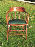 Captains chair. Captains chair covered in a green faux leather.