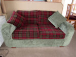 Matching sofa bed in a static caravan. Sofa bed in a static caravan - deep red tartan and contrasting pine green.