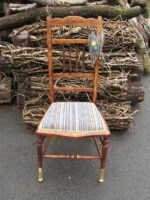 Delicate pin-stuffed chair. Delicate pin-stuffed chair with gold-dipped front legs.