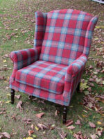 Parker Knoll Wingback Armchair. Parker Knoll Wingback Armchair covered in cherry/green tartan fabric (front view).
